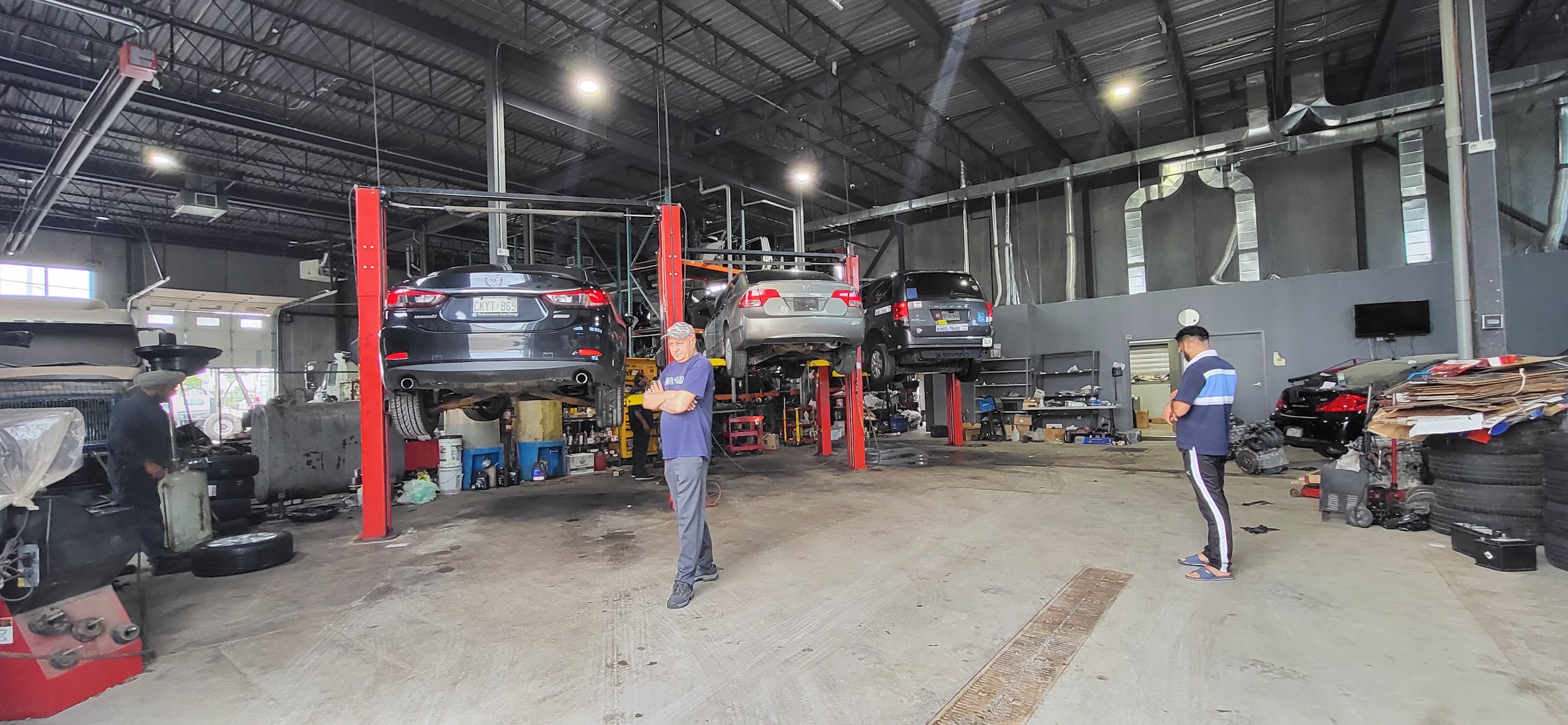 Inside the A1 Auto Repair shop floor with cars on lifts